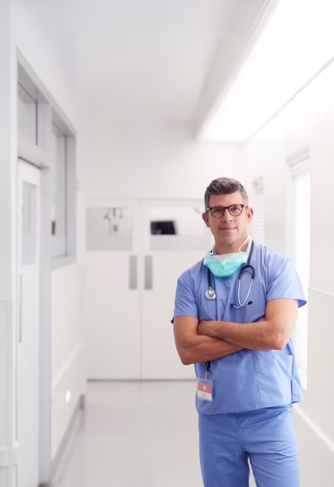 portrait-of-mature-male-doctor-wearing-scrubs-stan-2026-03-10-04-49-45-ut