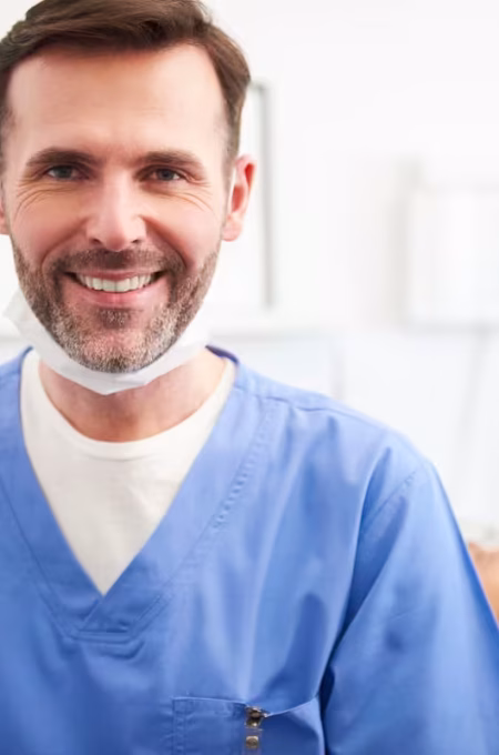 portrait-of-smiling-male-dentist-in-dentist-s-clin-2026-01-07-00-09-00-utc